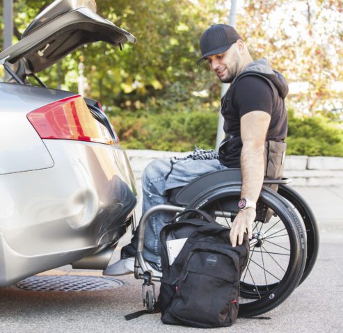man with wheelchair opening trunk