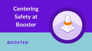 Badge with orange cone floats on purple and teal background. Words read "Centering Safety at Booster"