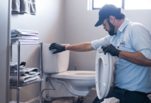 plumber fixing toilet