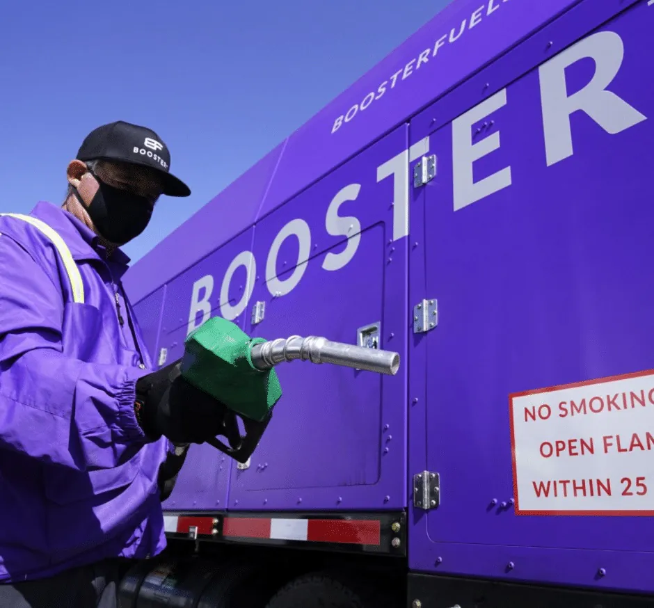 Booster service pro putting nozzle back in truck