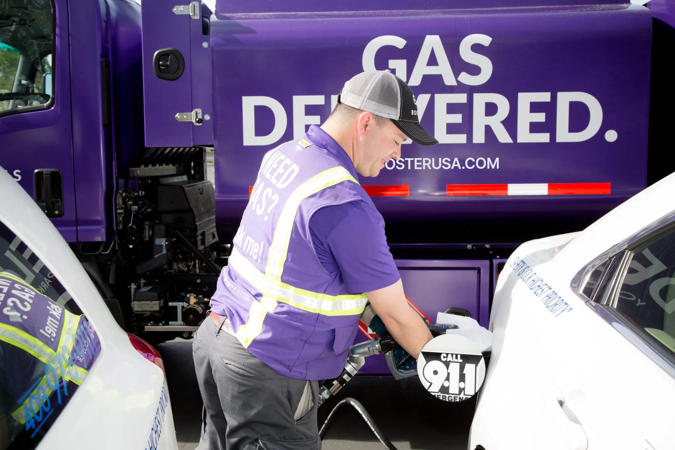 Booster professional fueling white vehicle from purple Smart Tanker