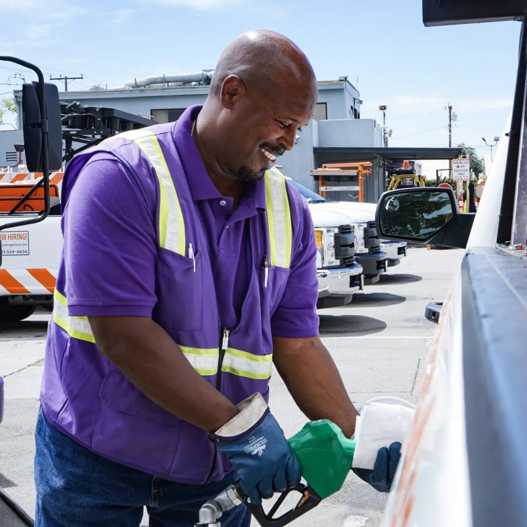 Black male Booster service professional fueling truck