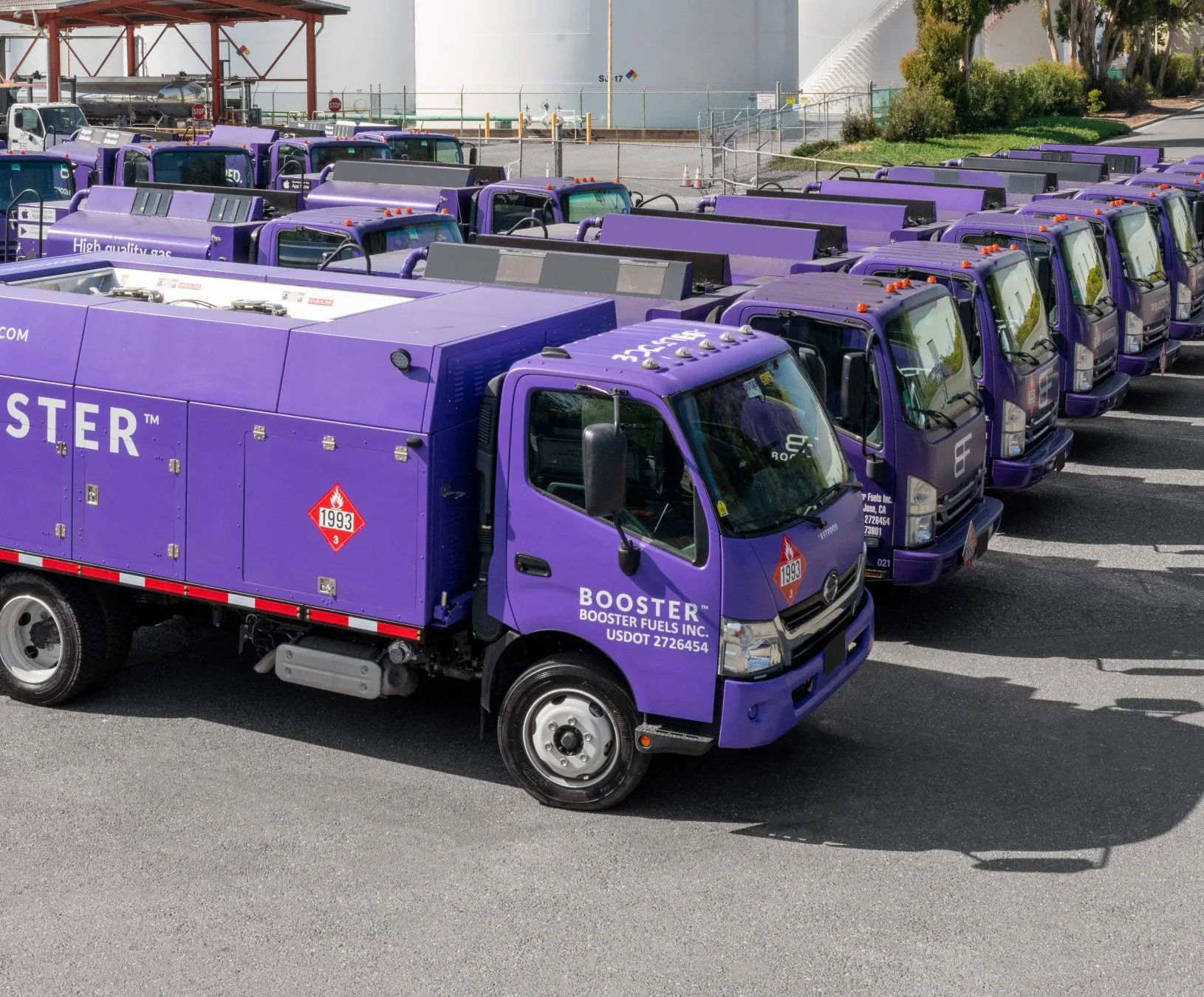 line of purple gas trucks