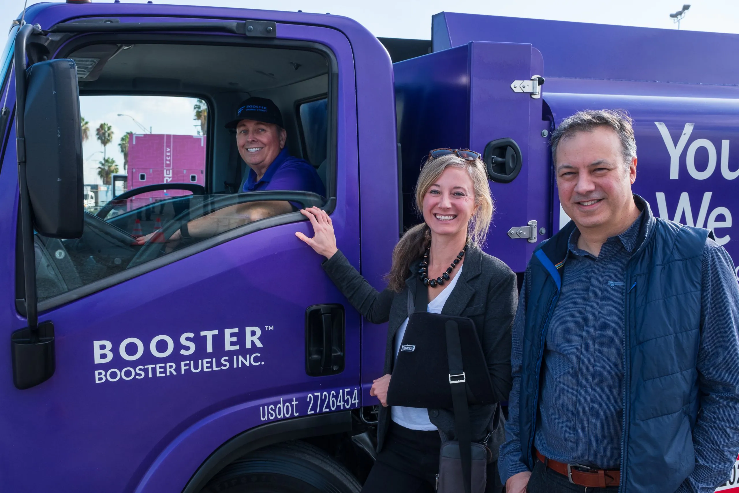 Booster Smart Tanker with driver behind wheel and clients at door