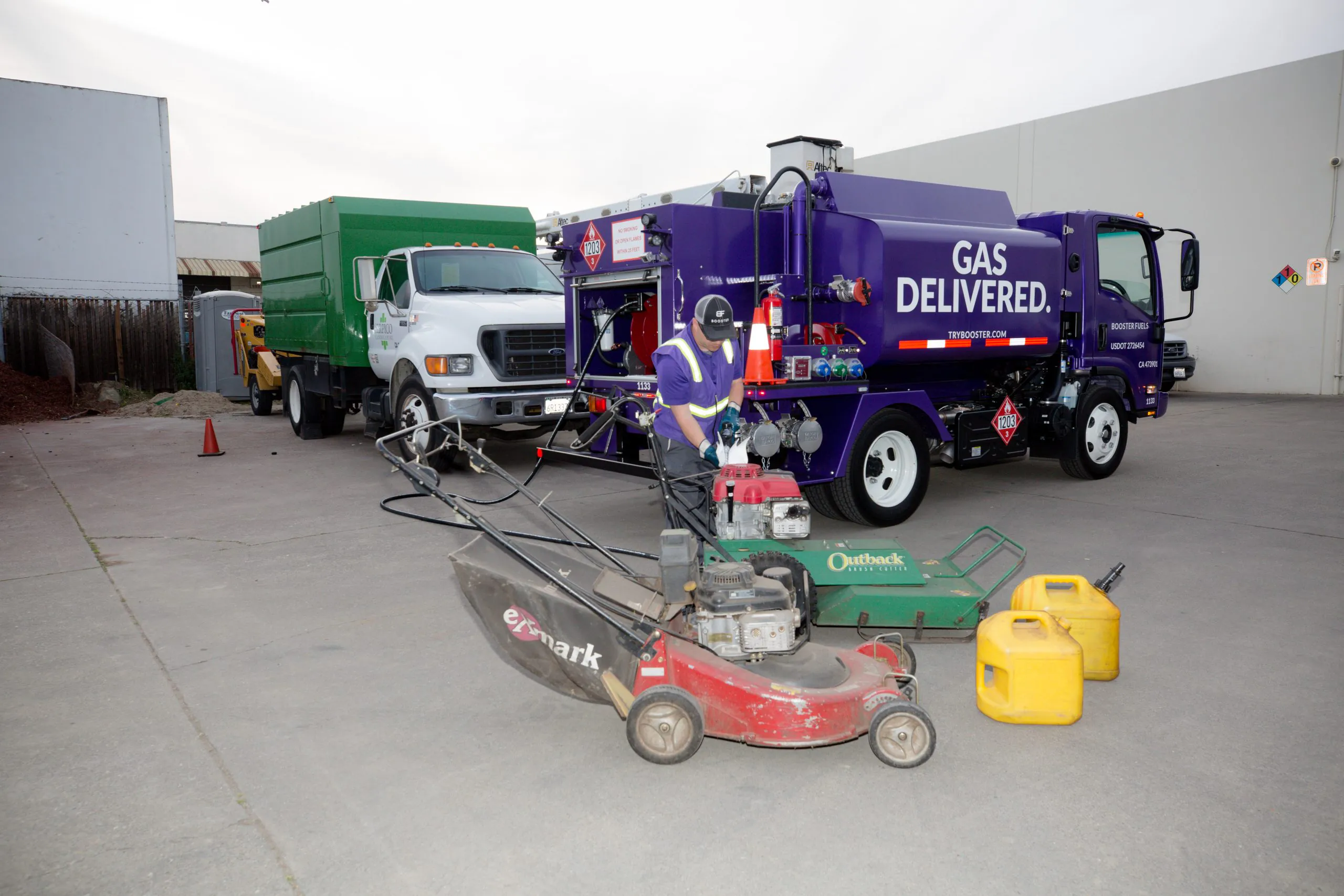 driver refueling lawnmowers and gas cans