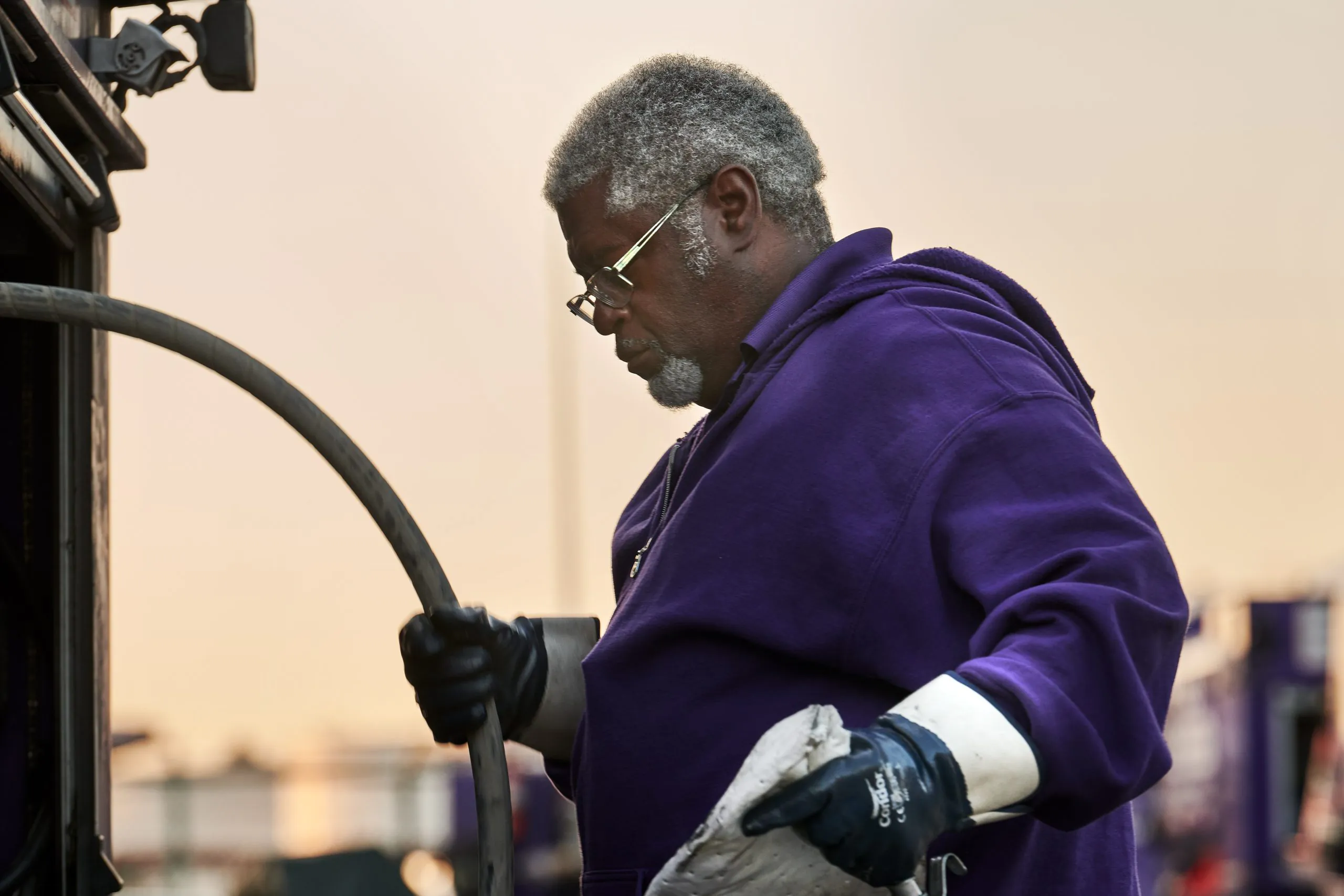 Black grey haired Booster service professional with wet hose fueling system