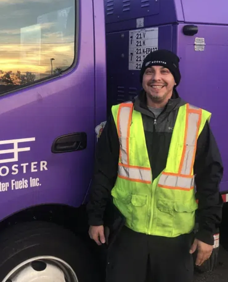 Booster service professional standing outside truck