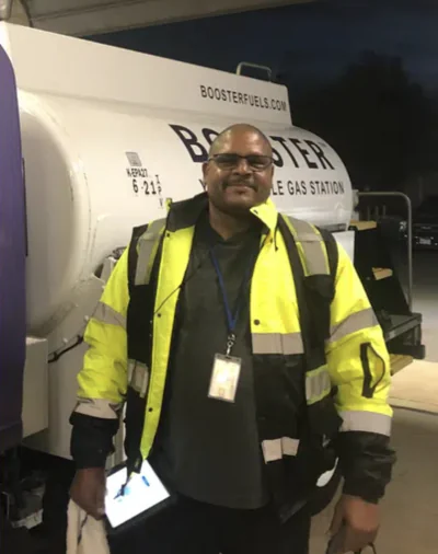 Booster service professional standing outside Smart Tanker