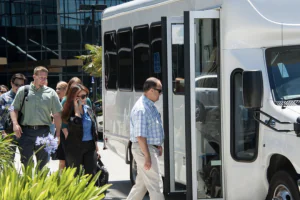 people boarding white transport van