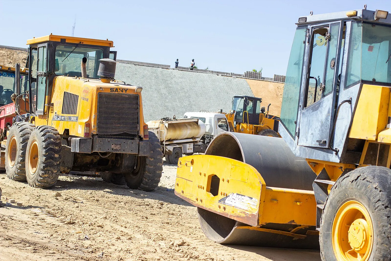 construction vehicle and paver on dirt